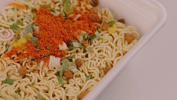 Dry instant noodles in styrofoam packaging.