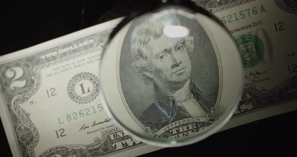 Two Dollar Us Banknote. $ 2 Cash Through A Magnifying Glass. 2 Bucks On Black.