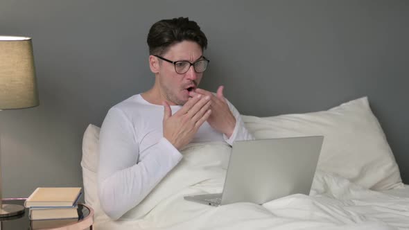 Middle Aged Man with Laptop Having Loss in Bed