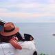 Young woman traveler looking at the beautiful sea view with her car while traveling - VideoHive Item for Sale