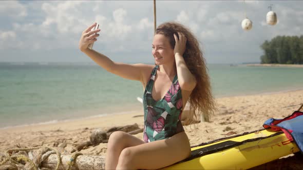 Attractive Woman Taking Selfie on Beach