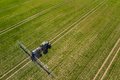 tractor spraying herbicides on field, Tractor Spraying Chemicals on Field - GMO Crops - PhotoDune Item for Sale