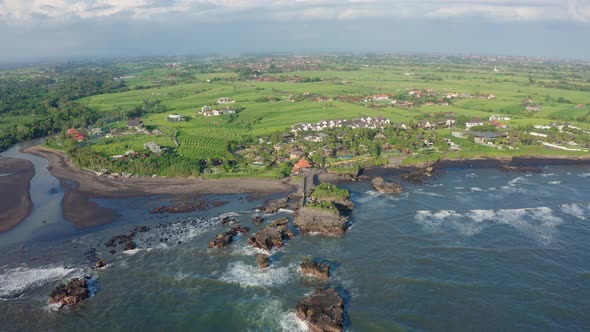 Aerial Footage of Black Volcanic Beach, Green Rice Terraces. Bali, Indonesia