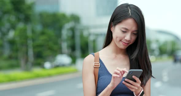 Woman working on mobile phone in Shenzhen city