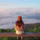 Young woman travelers looking at the sunrise and the sea of mist on the mountain - VideoHive Item for Sale