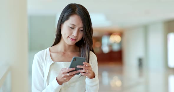 Woman working on cellphone inside compartment