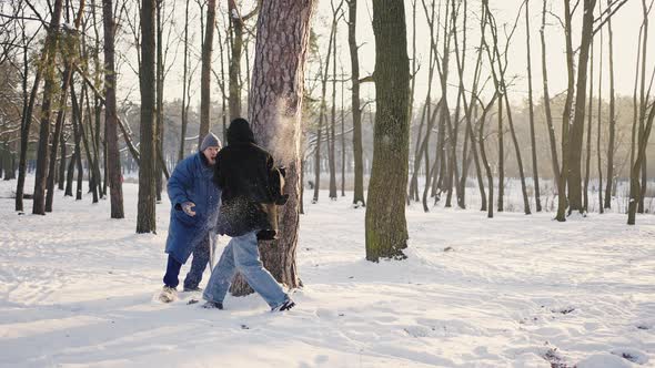 Young Couple Plays and Has Fun During a Winter Walk