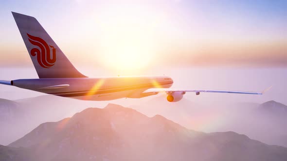 The airliner flew over the misty mountains at dawn