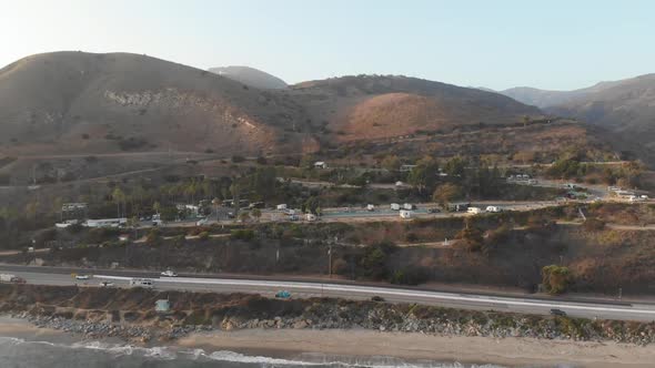 Aerial in Malibu, California of campground on the hillside facing the beach