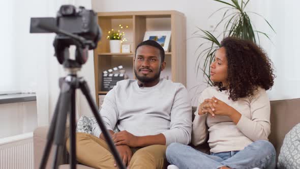 Couple of Video Bloggers with Camera at Home