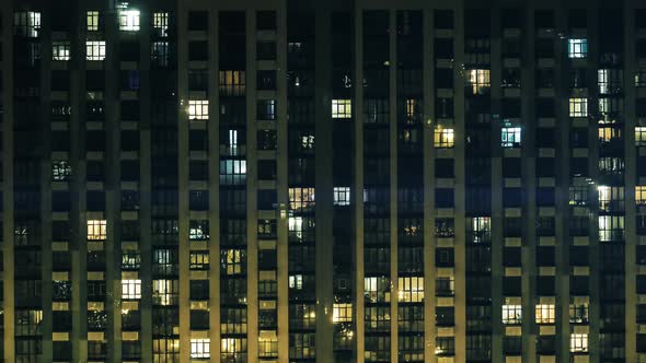 Night Panorama Timelapse of Light in Windows of Multistory Buildings. Rows of Glowing Windows with