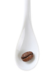 Single coffee bean on white spoon isolated on white - PhotoDune Item for Sale
