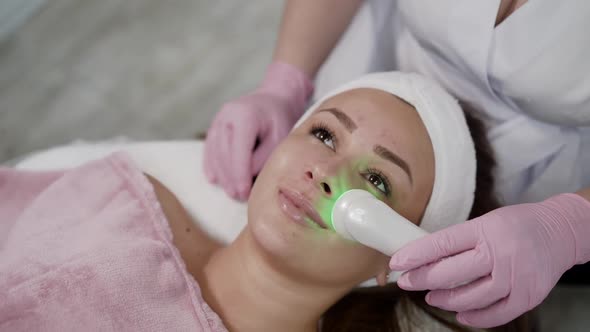 Pretty Girl Having Relaxing During Laser Cosmetology Procedure By Beautician