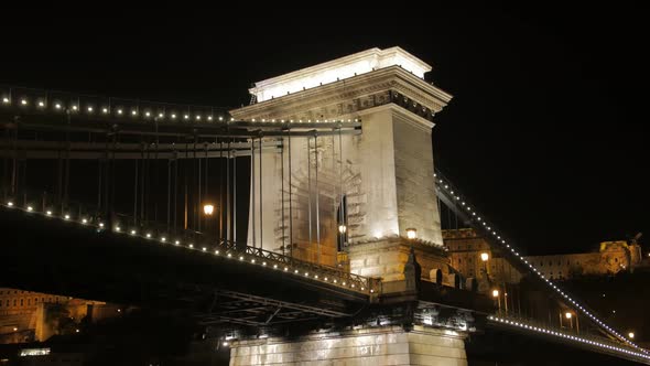 Old Illuminated Bridge At Night