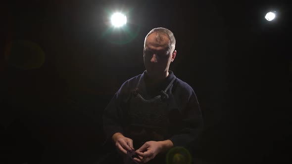 Kendo Warrior Is Putting on Helmet at Background Spotlights