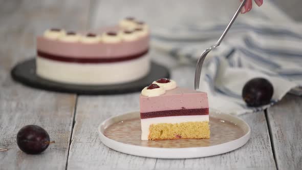 Piece of Delicious Mousse Cake with Whipped Cream and Plum Jelly