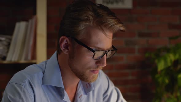 Busy Caucasian Male with Glasses Light Beard and Blue Shirt Questionably Looking