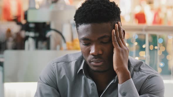 Closeup Young Unhealthy Tired African American Man Feels Headache Pressure Holding Hands on to Head