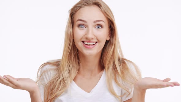 Young Beautiful Caucasian Blonde Girl Suprisingly Smiling on White Background