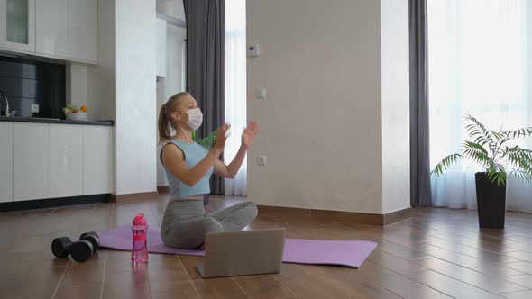 Woman in Medical Mask Practising Yoga at Home