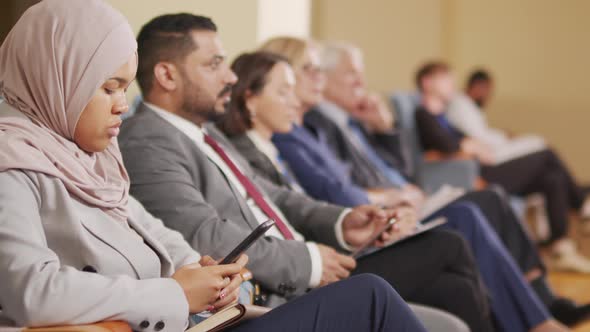 Business People Listening to Speaker at Conference