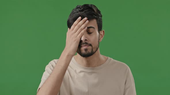 Male Angry Unsatisfied Portrait in Green Studio Arab Man Indian Irritated Young Guy Feel Displeasure