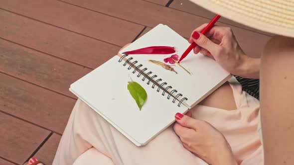 Woman Painting in Sketchbook by Pool