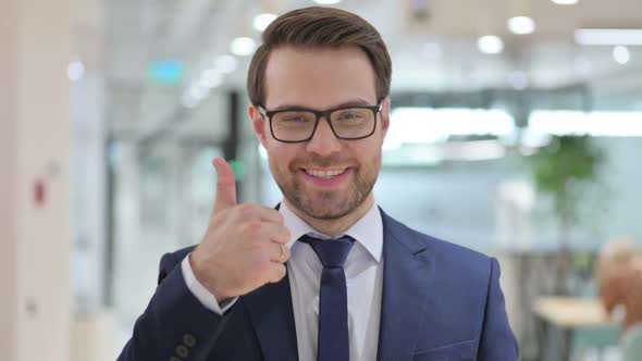 Portrait of Positive Businessman with Thumbs Up Sign