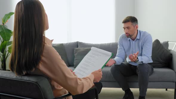 Woman Professional Psychologist Listen Client at Psychotherapy Session in Clinic