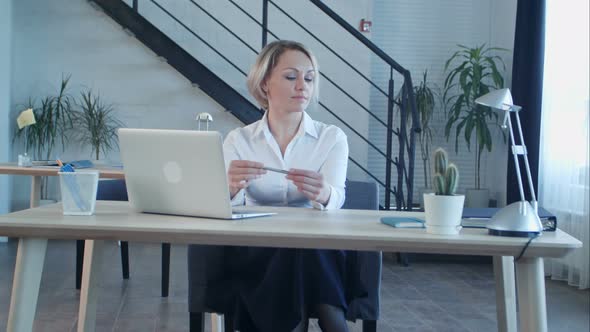 Unhappy Bored Woman Sitting in Office