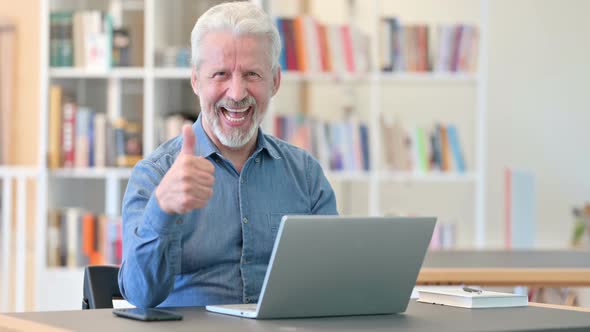 Positive Old Man with Laptop Doing Thumbs Up 