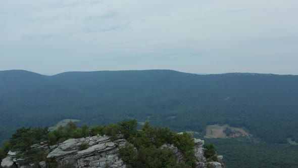 An aerial shot (dolly out) of Big Schloss and the Trout Run Valley in the evening in the summer, loc