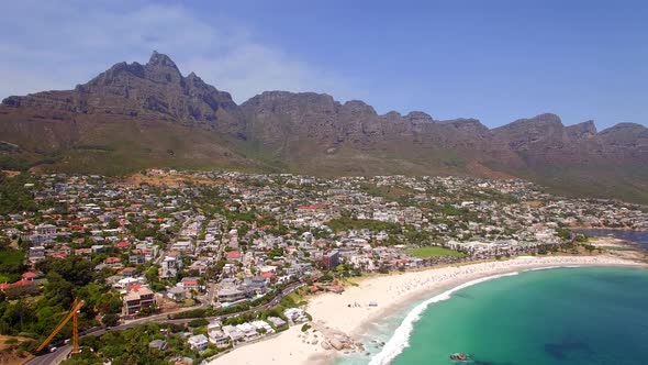 Aerial travel drone view of Camps Bay beach, Cape Town, South Africa.