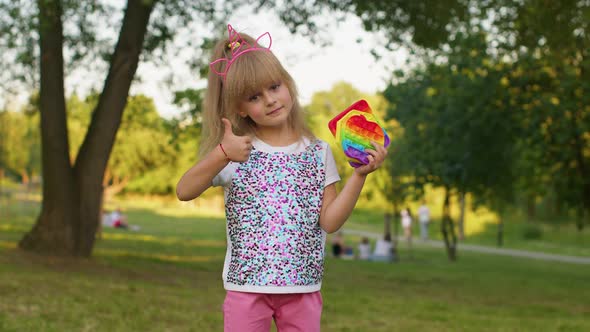 Child Girl Holding Many Colorful Squishy Silicone Bubbles Pop It Popular Sensory Toys Thumb Up