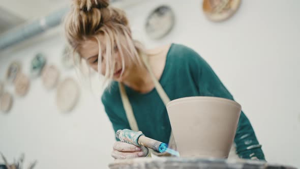Woman Making Ceramic Item at Studio Firing Pot on Pottery Wheel Below View Slow Motion