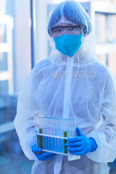 and mask holding test tubes with liquid and analysis in the lab