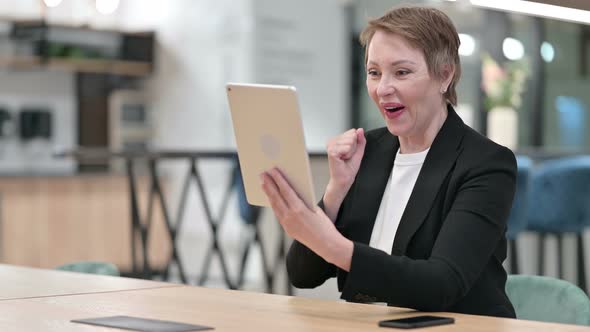 Excited Old Businesswoman Celebrating Success on Tablet 