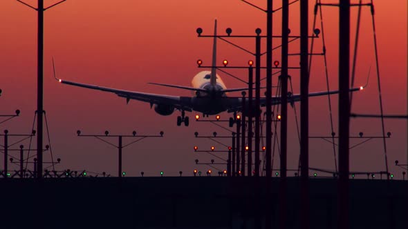 Jet Landing At Airport At Sunset