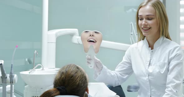 Dentist Showing Patient Result of Whitening