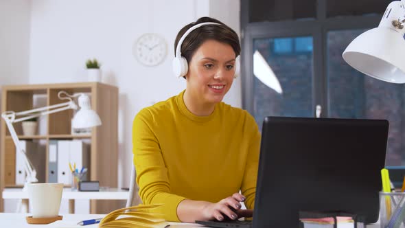 Creative Woman in Headphones with Laptop at Office 45