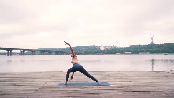 Girl Doing Fitness Exercises By the City River