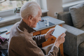 Positive Senior using Digital Tablet - PhotoDune Item for Sale