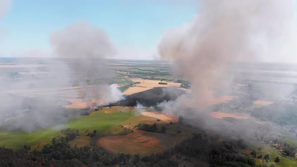 Aerial View of Fire in Wheat Field. Flying Over Smoke Above Agricultural Fields