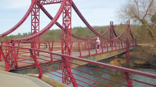 Girl Rides A Scooter On The Bridge