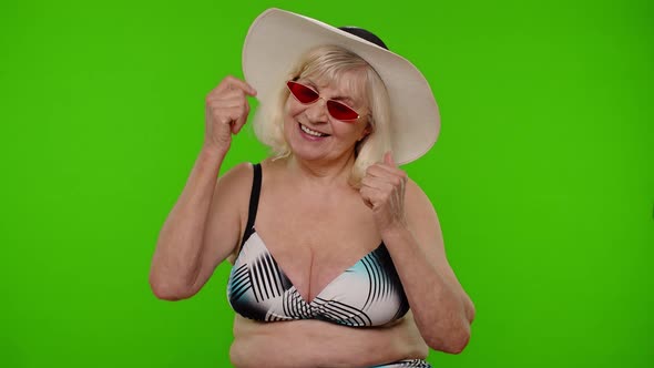 Senior Pensioner Woman Tourist in Swimsuit Bra Red Sunglasses and Hat Dancing Celebrating Smiling