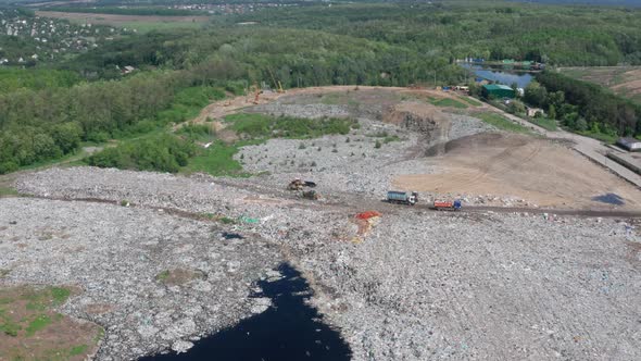 Drone Shot of Dump Trucks Working on City Landfill