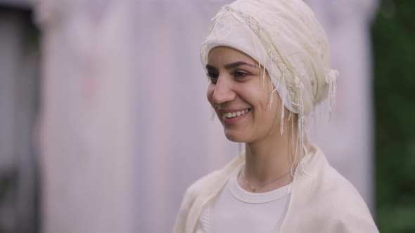 Closeup Portrait of Happy Young Middle Eastern Bride in White Hijab Laughing Listening Wedding Vows