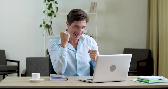 Excited Happy Businessman Reading Good News on Laptop Feeling Delight. Amazed Male Professional