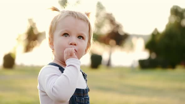 Portrait of Girl with Lollipop Outdoors