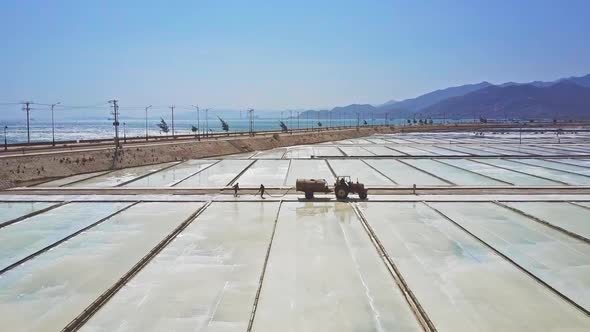 Tank Tractor Drives on Salt Plantations By Ocean